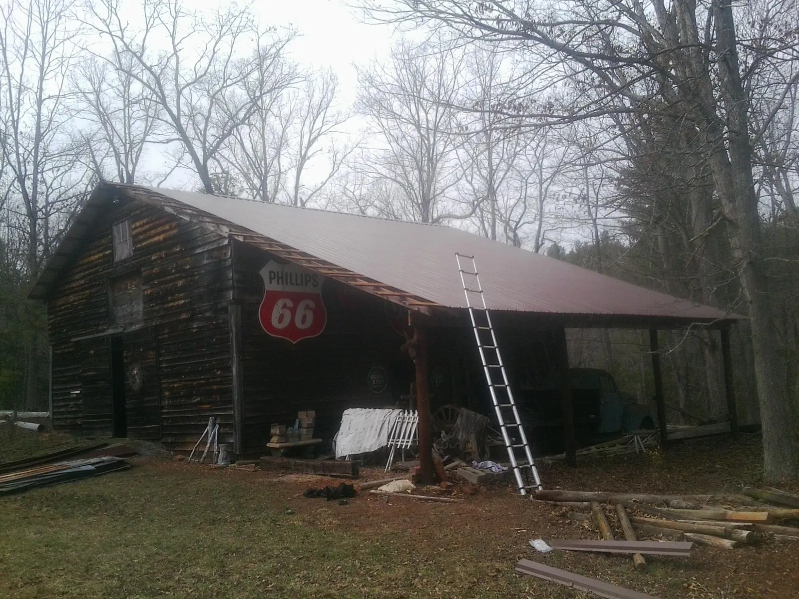 New metal roof on an open sided timber barn with a vintage sign in Smyrna